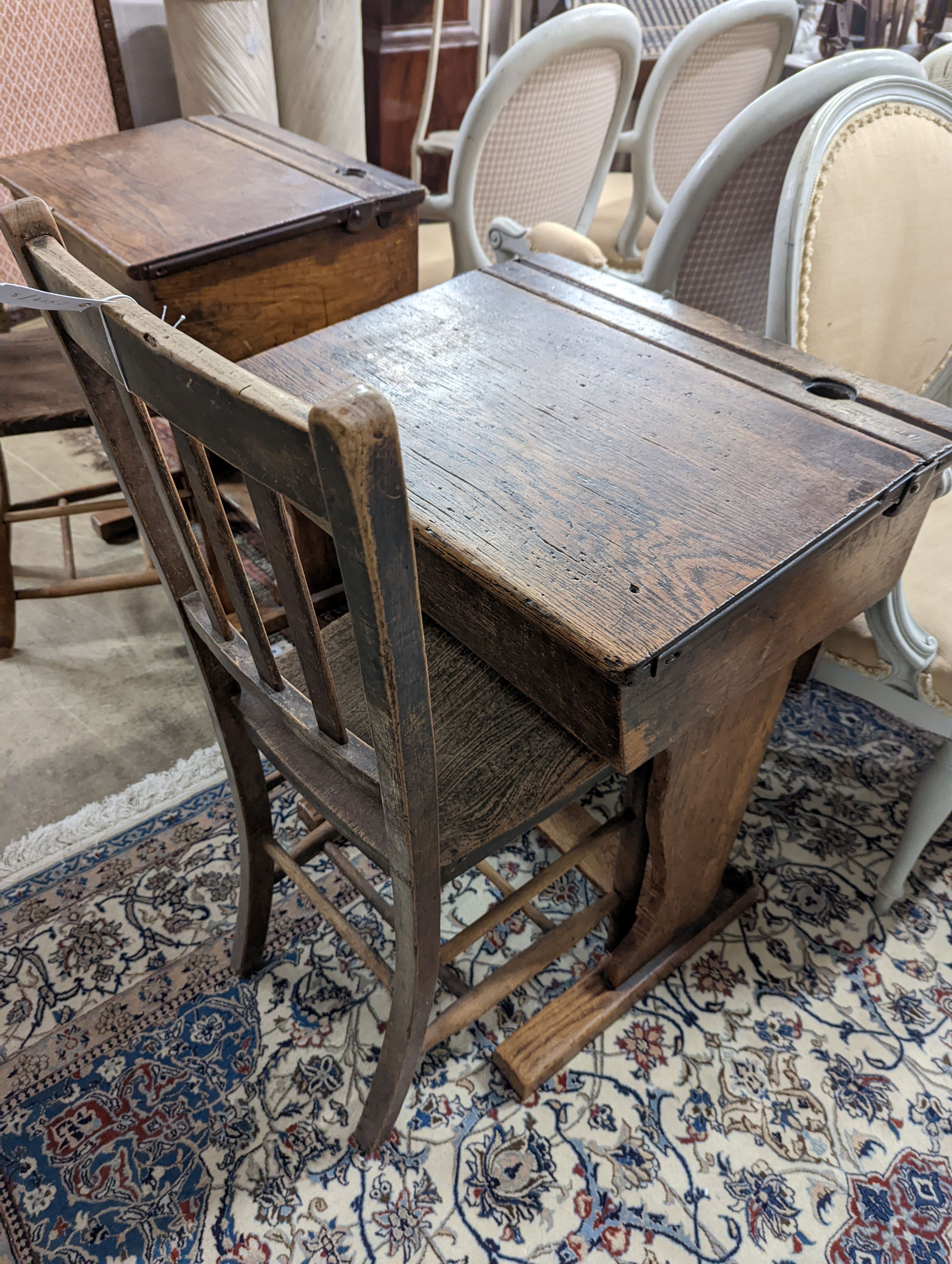 A vintage oak student's desk, width 57cm, depth 46cm, height 71cm with a beech and elm chair